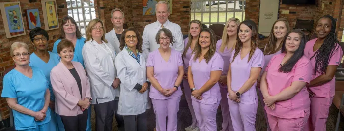 The Fayetteville Children’s Clinic team gathered in the brick-walled waiting room